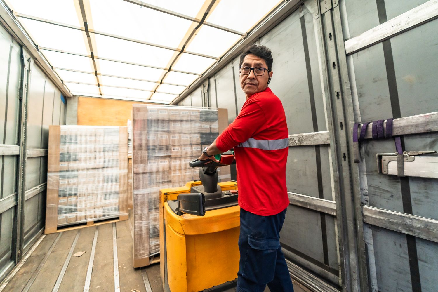 man offloading truck with goods